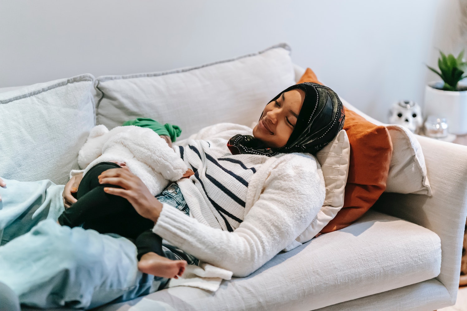 Parent breastfeeding on couch